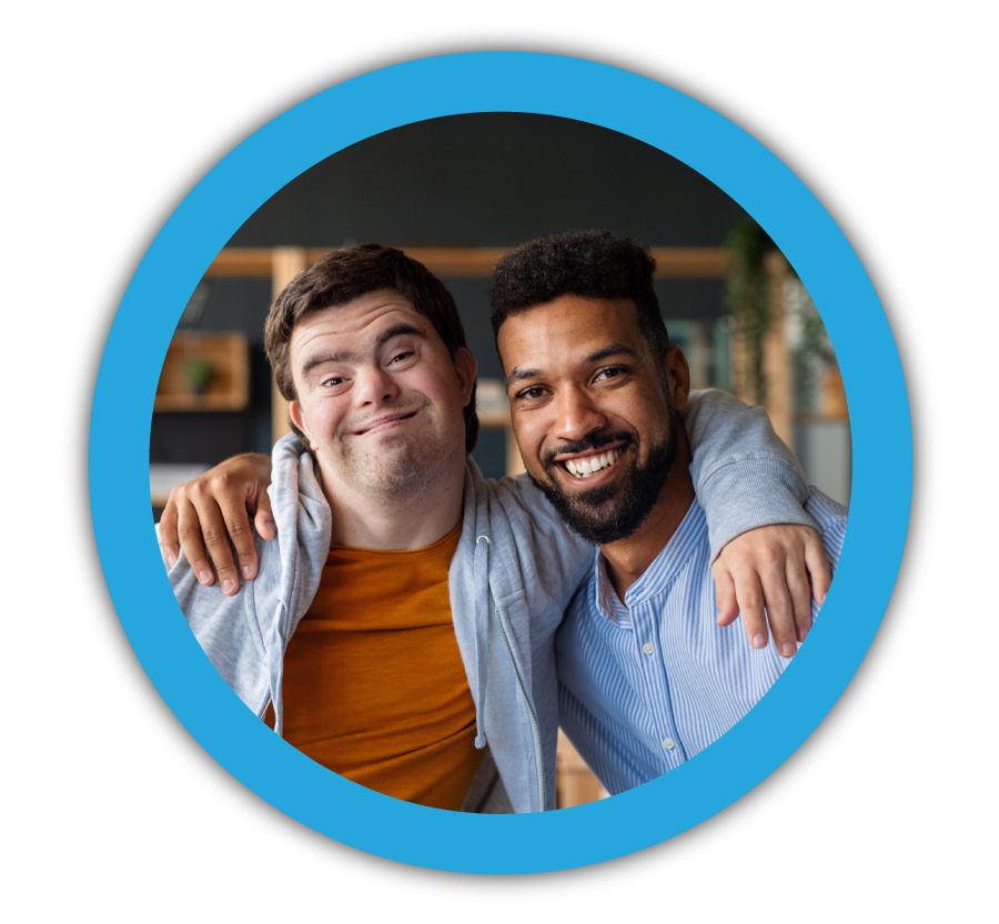 Image of a young man posing with a man with Down Syndrome.